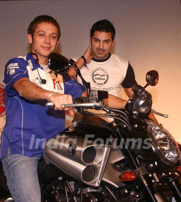 Motogp world champion Valentino Rossi and Bollywood actor John Abraham at a press meet in New Delhi on Sunday