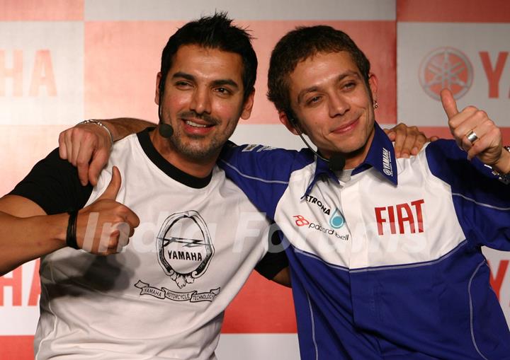 Motogp world champion Valentino Rossi and Bollywood actor John Abraham at a press meet in New Delhi on Sunday