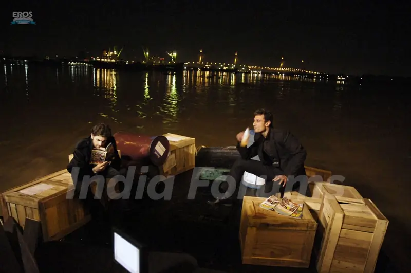 Neil and Rahul sitting on a beach