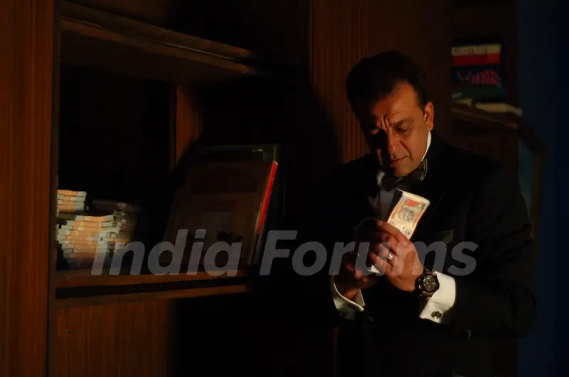 Sanjay Dutt with a bundle of Rupees