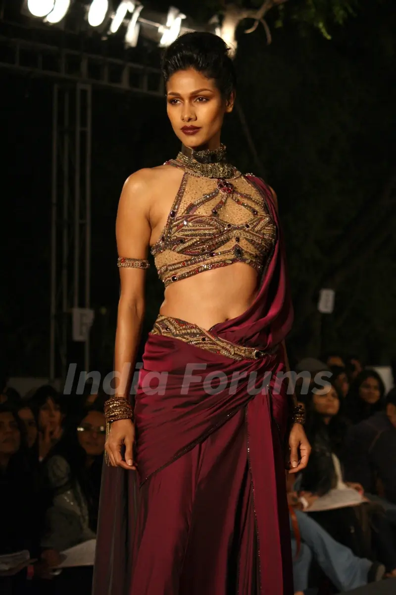 A model displays a creation by designer Tarun Tahiliani at the Wills Lifestyle India Fashion week 2012,in New Delhi on Thursday. .