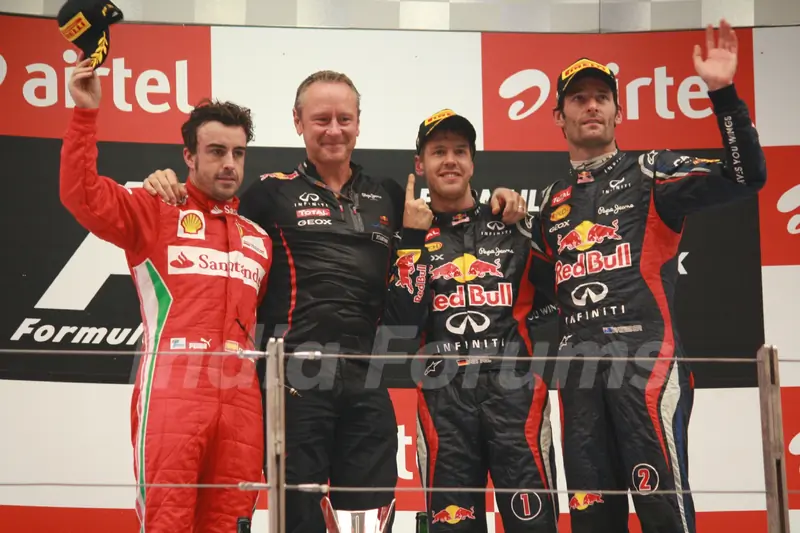Red Bull Formula One driver Sebastian Vettel celebrates on podium with Fernando Alonso & Mark Webber