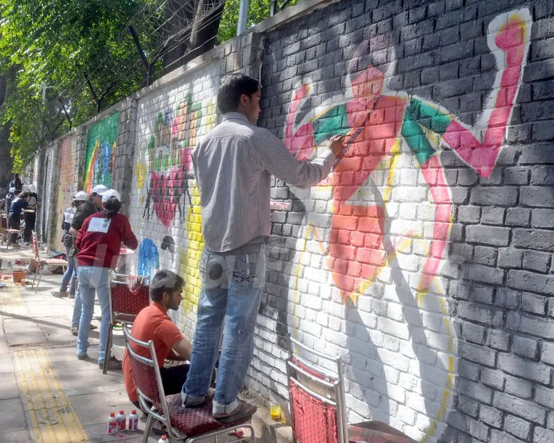 Artists create wall paintings during the 'Design The Change' wall art event at Delhi University (North Campus) in New Delhi on Feb. 24, 2013. The activity brought together more than 500 professional and budding artists on the same platform to ...