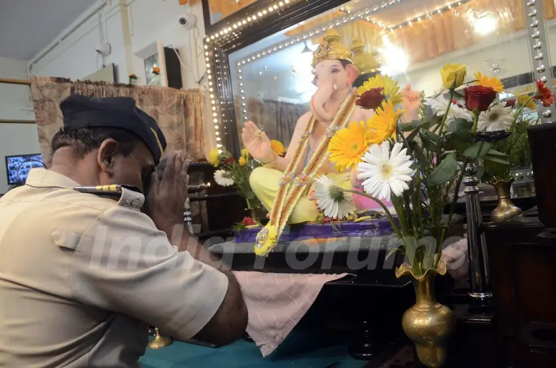 A constable seeks blessings of Lord Ganesha