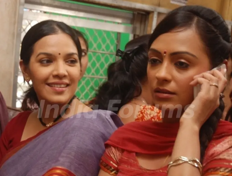 Nanda and Bubly sitting on a train