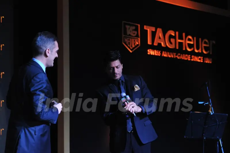 Shahrukh Khan tries on a watch at The Golden Era of the Carrera event by TAG Heuer