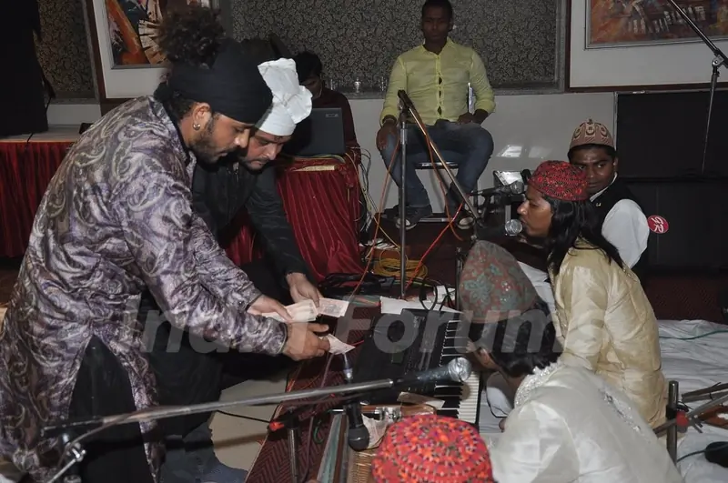 Sharib gives some money as a token of gratitude at the Sufi Mehfil