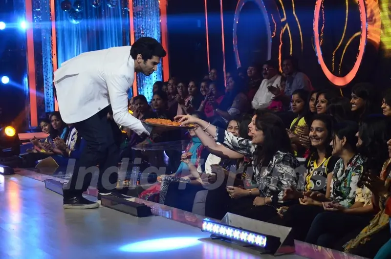 Aditya Roy Kapur distributes sweets to the audience on Jhalak Dikhhlaa Jaa