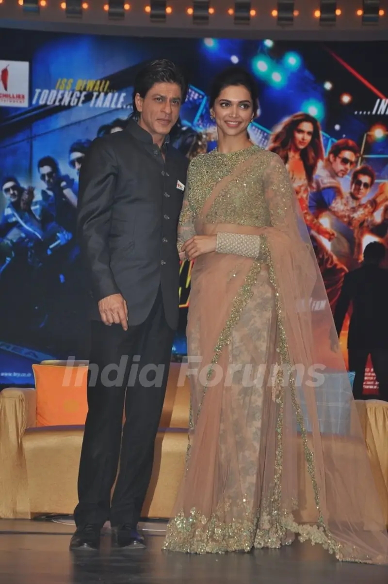 Shah Rukh Khan and Deepika Padukone pose for the media at the Music Launch of Happy New Year