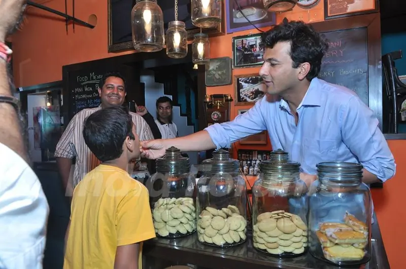 Vikas Khanna gives children some sweets at the Launch of Twist Of Taste - The Sweet Life