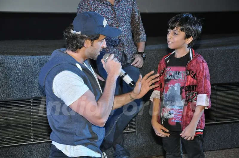 Hrithik Roshan interacts with a young fan at the Special Screening of Bang Bang