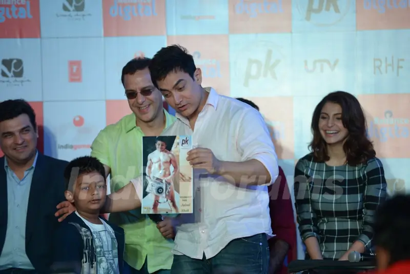 Aamir Khan interacts with a young fan at P.K. Game Launch