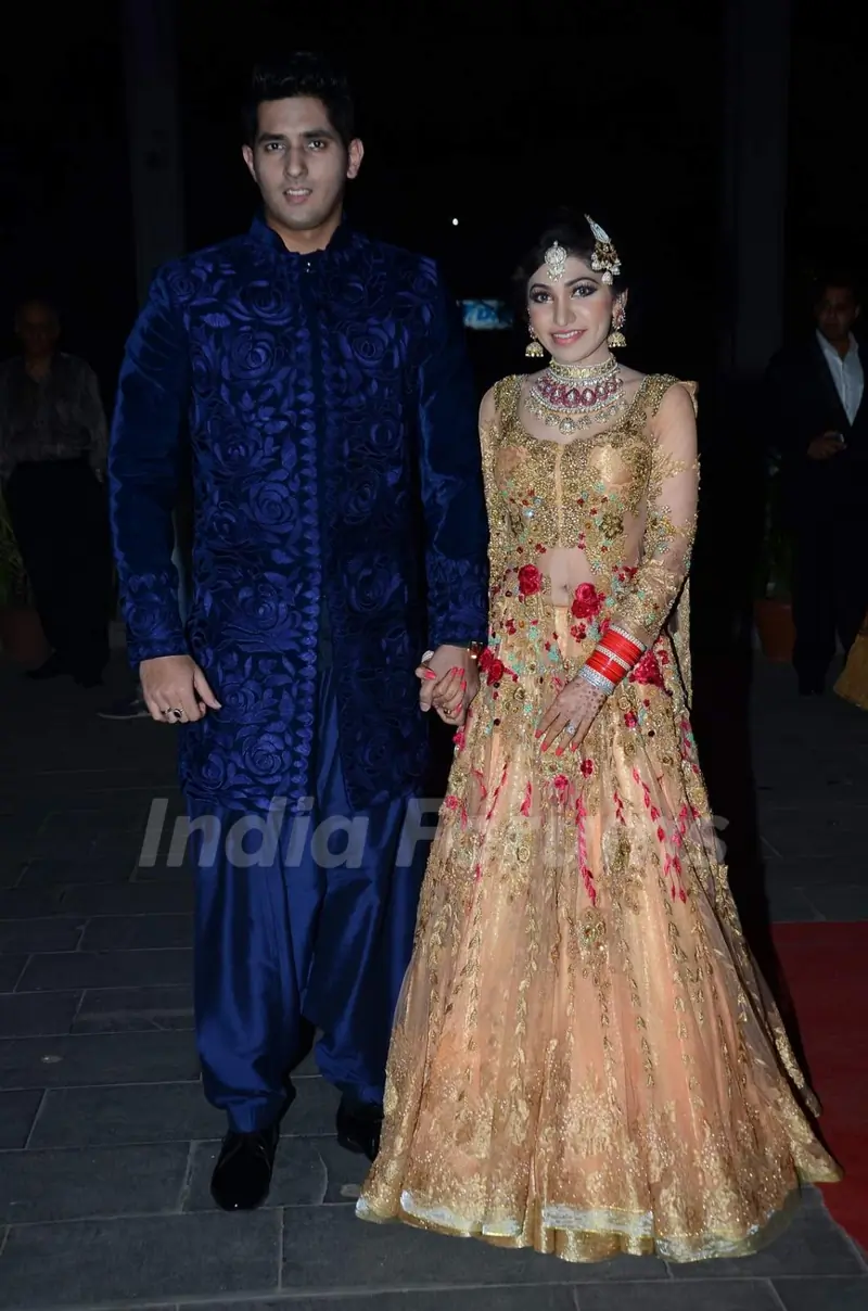 Tulsi Kumar and Hitesh Rahlan pose for the media at their Wedding Reception