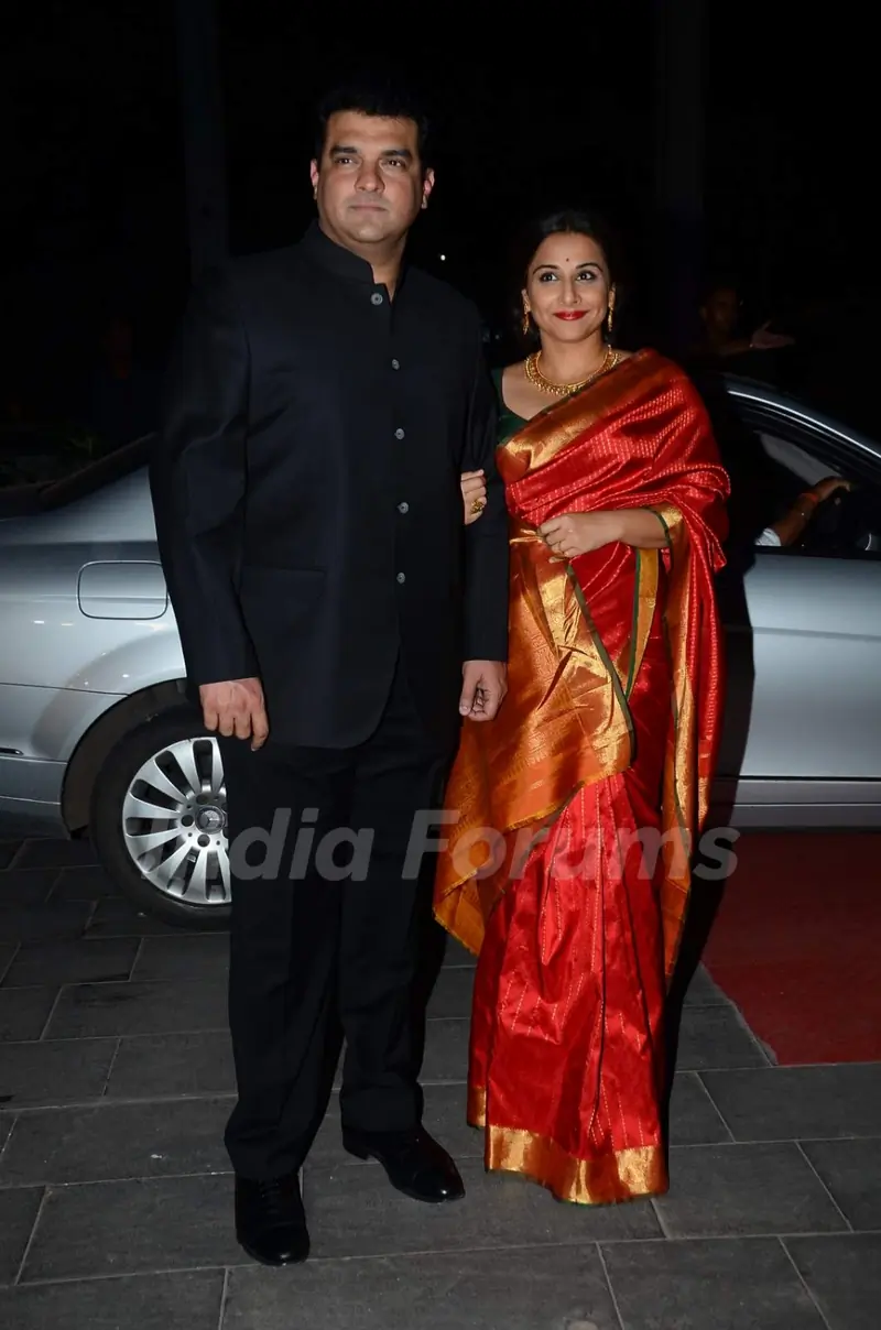 Siddharth Roy Kapoor and Vidya Balan pose for the media at Tulsi Kumar's Wedding Reception