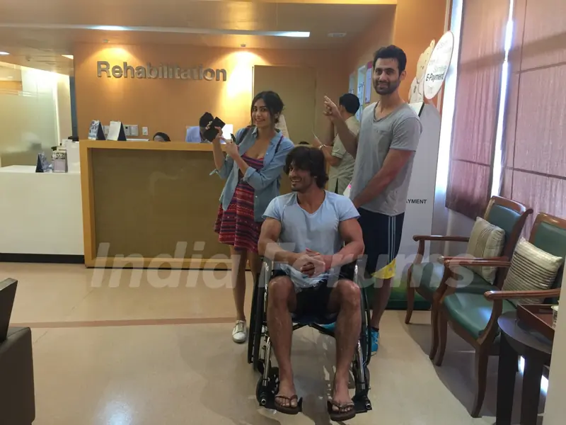 Picture of Vidyut Jamwal who is seen sitting on a wheelchair accompanied by his co-stars.