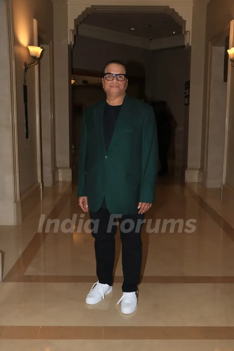 Ramesh Taurani poses to paparazzi at an award function