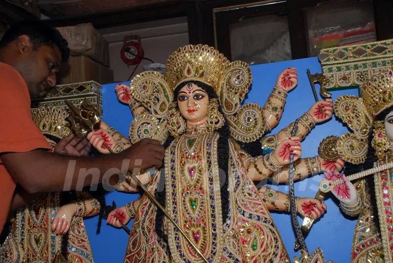 An Artist of Kumartuli finishing touch at a Durga idol made by Shola (Pith) for overseas country (Canada) in Kolkata on Wednesday 12th Aug 09