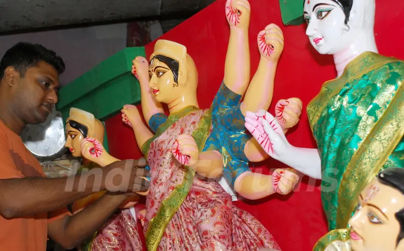 An Artist of Kumartuli finishing touch at a Durga idol made by Shola (Pith) for Overseas country in Kolkata on Wednesday 12th Aug 09