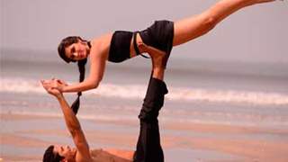 Bruna and Omar rehearsing some acro-yoga moves on the beach